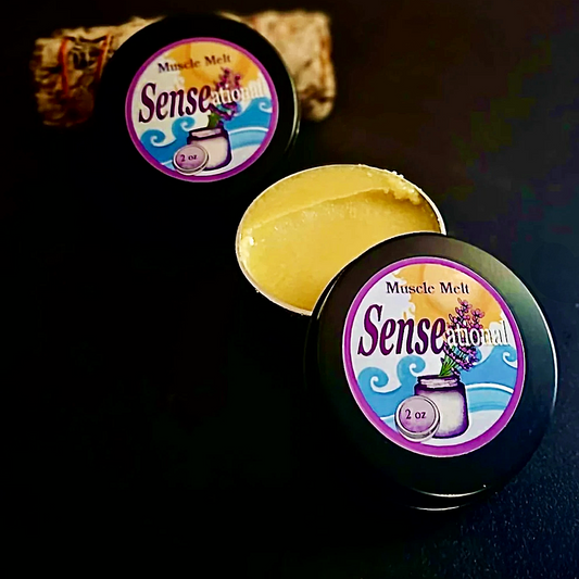 Two Muscle Melt salve, one open muscle melt balm container showing content and another one in the background.